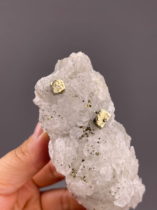 Calcite from Longyan, Fujian, China: oblique close view of two bright metallic crystal faces.