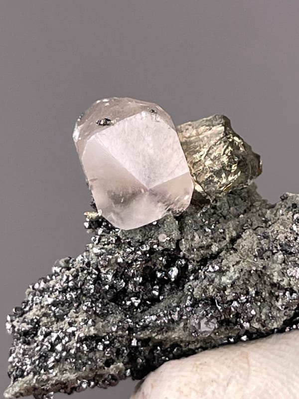 Calcite specimen from Shizhuyuan Mine, Hunan, China bearing milky calcite on sparkling matrix