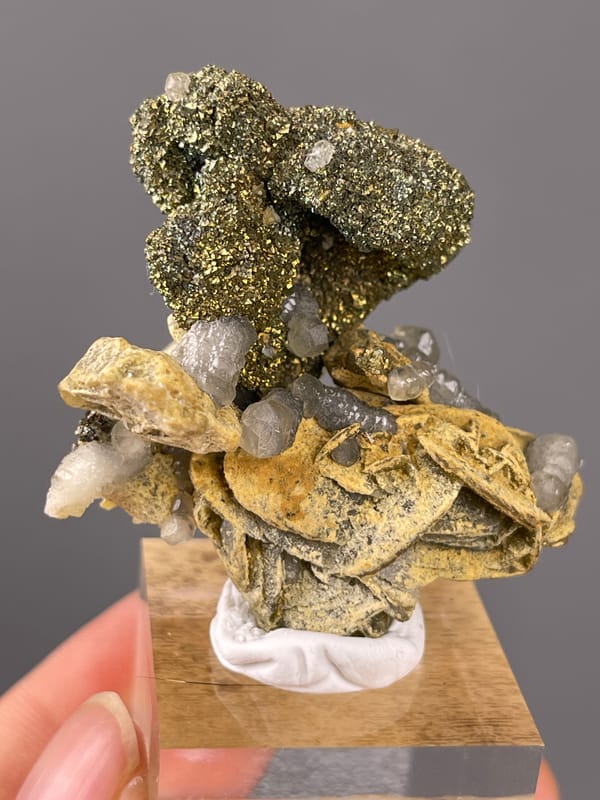 Calcite specimen from China showing brassy masses above tan blades