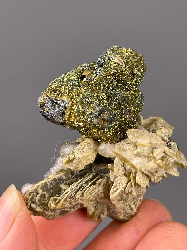 Calcite specimen from China highlighting brassy masses above tan blades