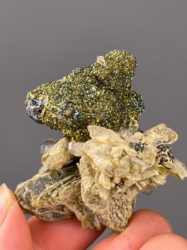 Calcite specimen from China, characterized by brassy masses above tan blades