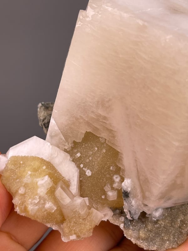 Off-white cleaved prismatic crystal on natural calcite specimen from Fujian, China