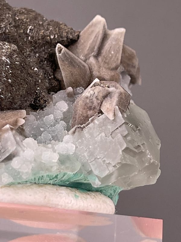 Calcite specimen from Longyan, Fujian, China bearing dark globules with tan blades and green crystal