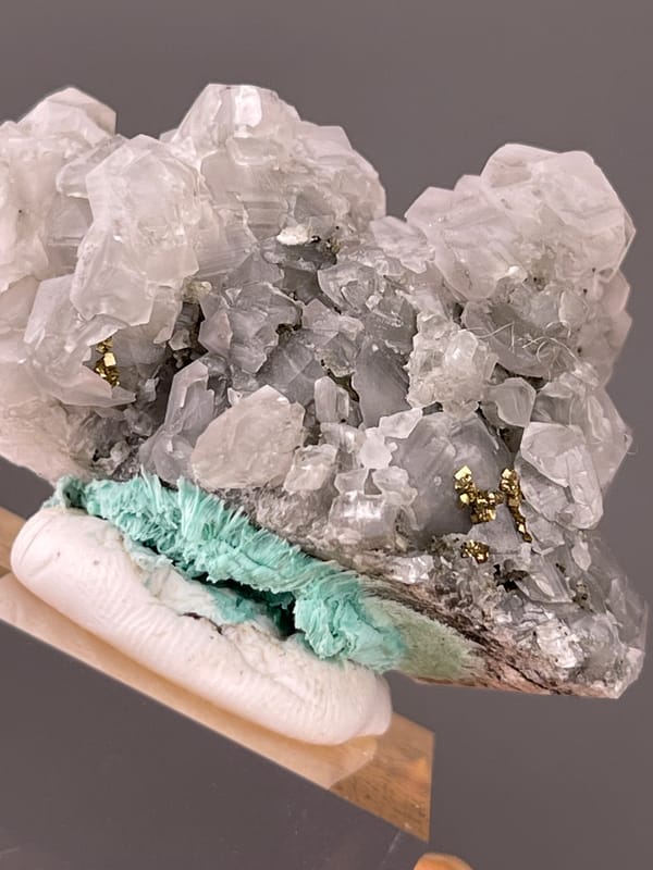 Calcite specimen from Longyan, Fujian, China displaying pale gray calcite with brassy pyrite