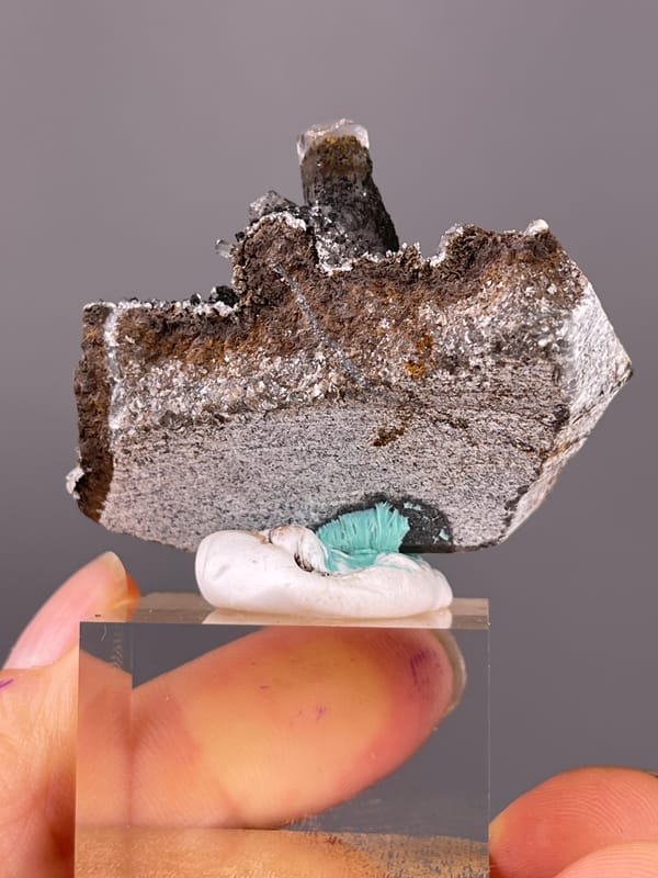 Calcite specimen from Longyan, Fujian, China highlighting dark prismatic crystals with brassy coating