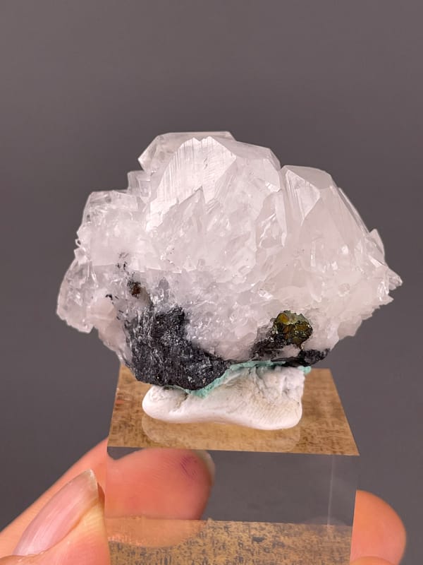 Calcite specimen from Longyan, Fujian, China showing clear calcite cluster over dark matrix