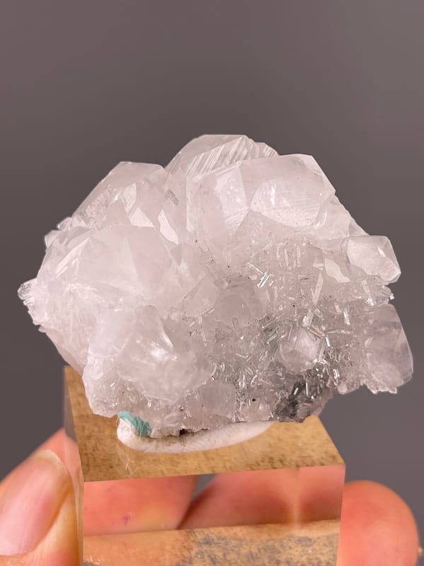 Clear calcite cluster over dark matrix on natural calcite specimen from Longyan, Fujian, China