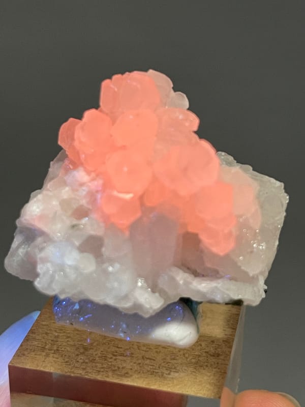 Calcite specimen from Longyan, Fujian, China showcasing orange calcite fluorescence under ultraviolet light