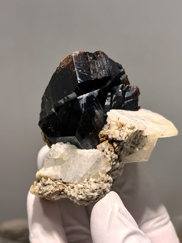 Large black cassiterite with albite, calcite and mica from Xuebaoding, Sichuan, China, second angle