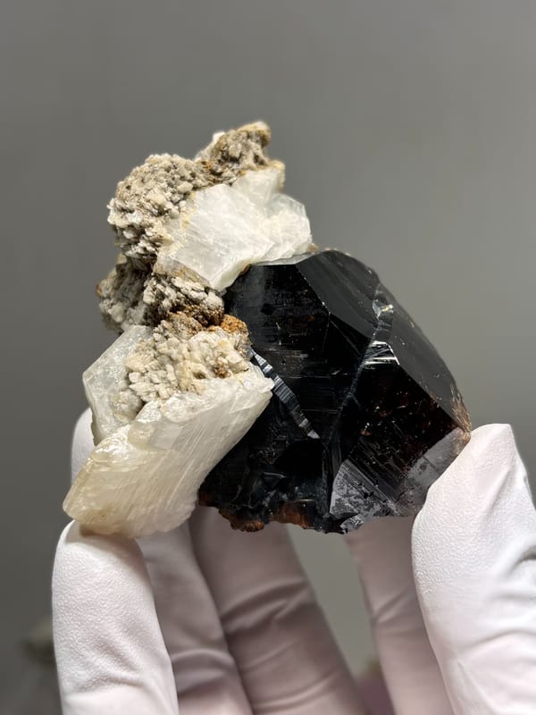 Large black cassiterite with albite, calcite and mica from Xuebaoding, Sichuan, China, reverse side