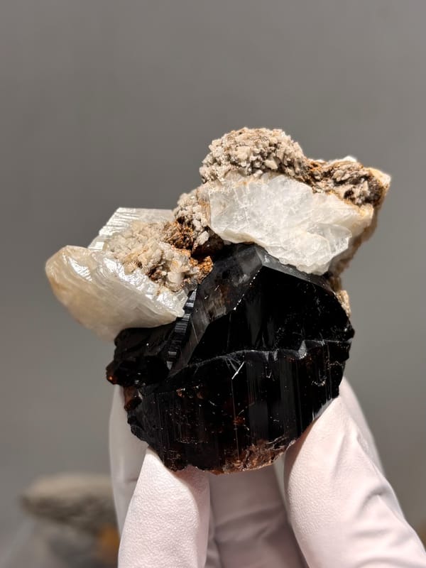 Large black cassiterite with albite, calcite and mica from Xuebaoding, Sichuan, China, top view