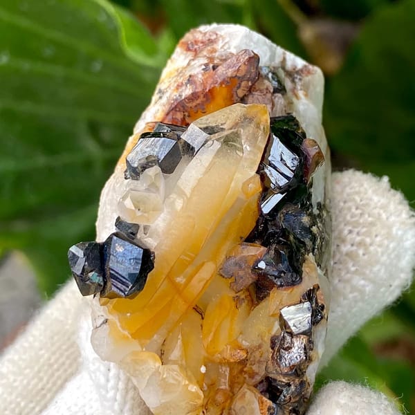 Glossy black cassiterite crystals with honey citrine on white matrix from Yunnan, China, view 3 of 9