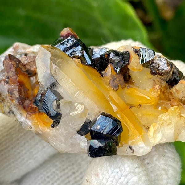 Glossy black cassiterite crystals with honey citrine on white matrix from Yunnan, China, view 4 of 9