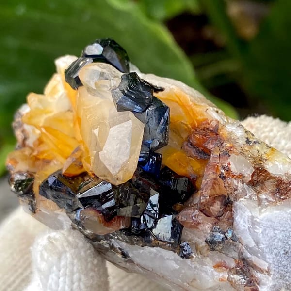 Glossy black cassiterite crystals with honey citrine on white matrix from Yunnan, China, view 8 of 9