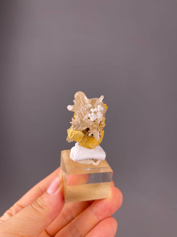 Colorless striated prisms visible on cerussite specimen from Iran