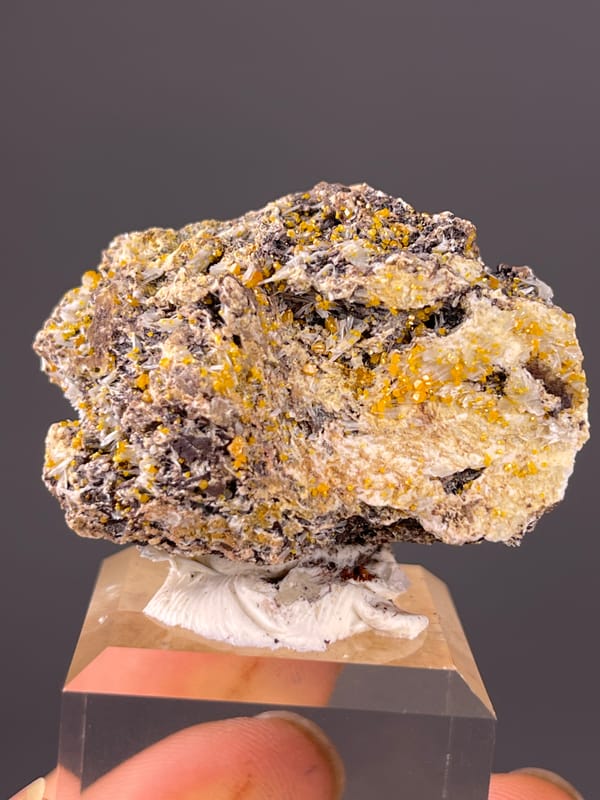 Chabazite specimen from Fujian, China featuring dark blades with yellow-orange coating