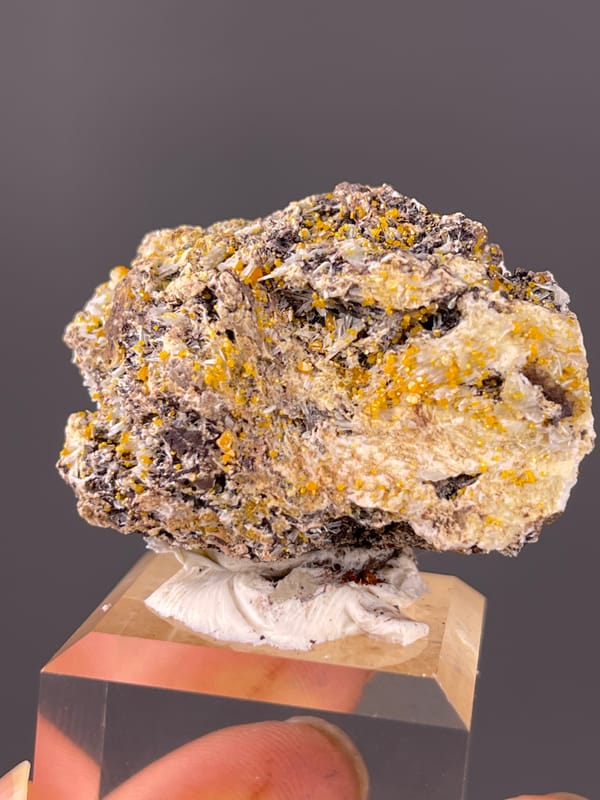 Chabazite specimen from Fujian, China showing dark blades with yellow-orange coating