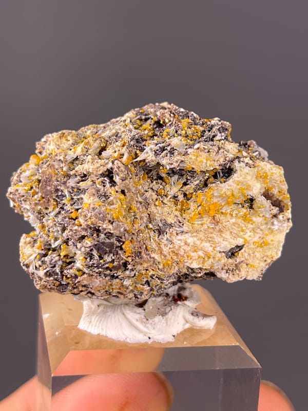 Chabazite specimen from Fujian, China presenting dark blades with yellow-orange coating