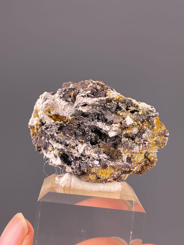 Chabazite specimen from Fujian, China highlighting dark blades with yellow-orange coating