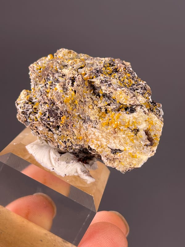 Chabazite specimen from Fujian, China bearing dark blades with yellow-orange coating