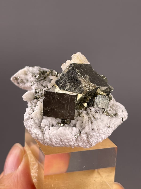 Chalcopyrite from Shangbao, Hunan, China: close front view of broad dark brassy square looking faces.