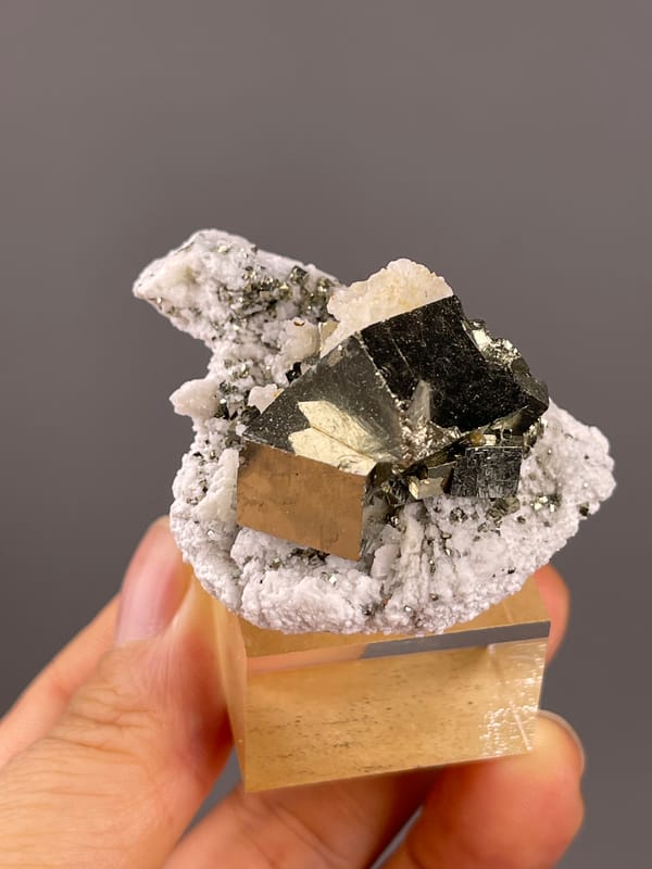 Chalcopyrite from Shangbao, Hunan, China: oblique view of reflective metallic faces and pale growths.