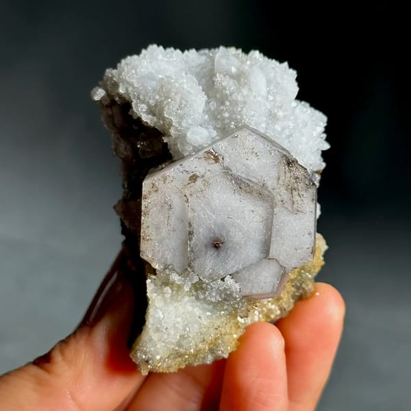 Hexagonal chocolate-sandwich calcite, from Fujian, China, front view in daylight
