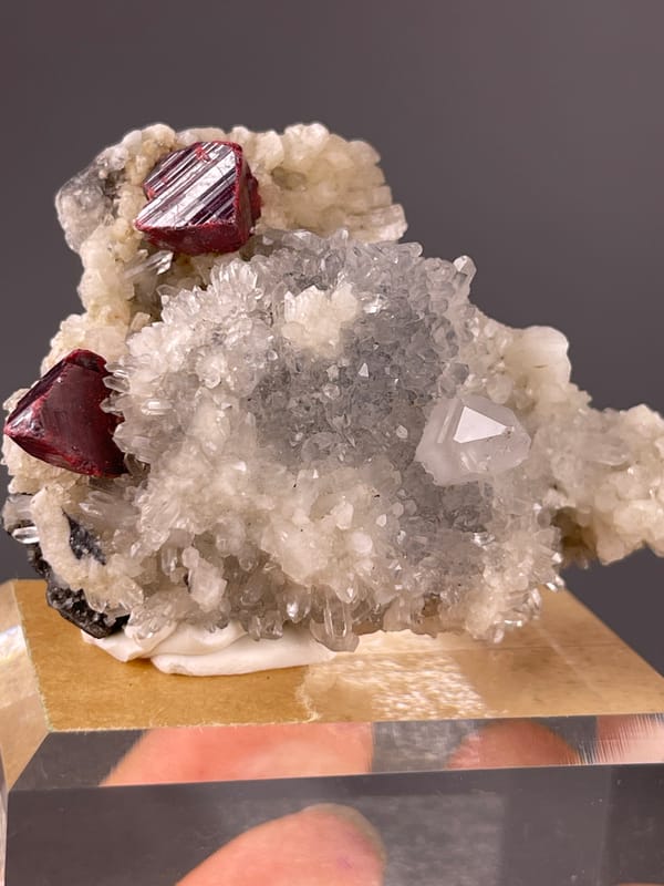 Cinnabar specimen from Maxianxi, Hunan, China featuring red-brown crystals on white druse