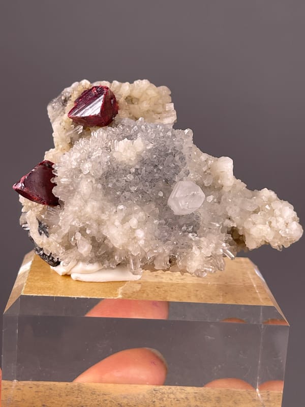 Cinnabar specimen from Maxianxi, Hunan, China showing red-brown crystals on white druse
