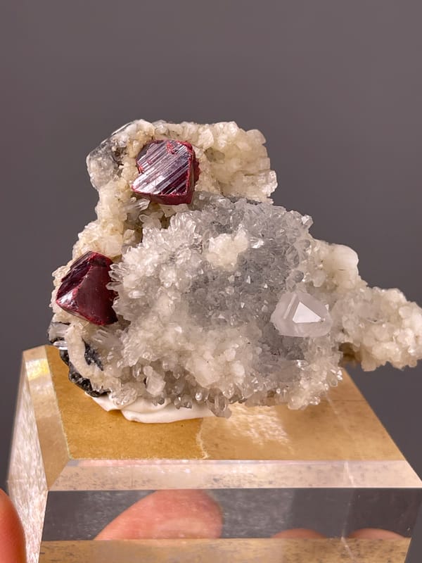 Cinnabar specimen from Maxianxi, Hunan, China presenting red-brown crystals on white druse
