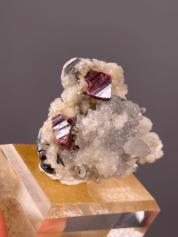Cinnabar specimen from Maxianxi, Hunan, China displaying red-brown crystals on white druse