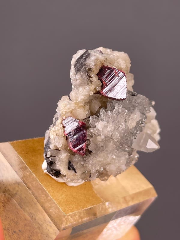Red-brown crystals on white druse on natural cinnabar specimen from Maxianxi, Hunan, China