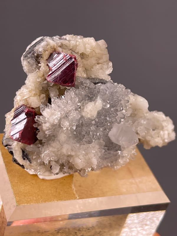 Cinnabar specimen from Maxianxi, Hunan, China highlighting red-brown crystals on white druse
