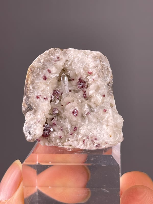 Cinnabar specimen from Hunan, China featuring reddish crystals in white matrix