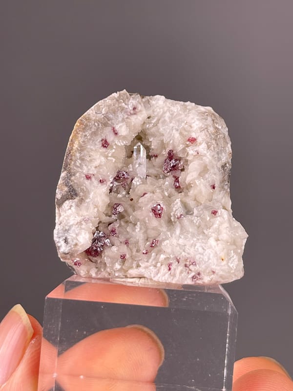 Cinnabar specimen from Hunan, China presenting reddish crystals in white matrix
