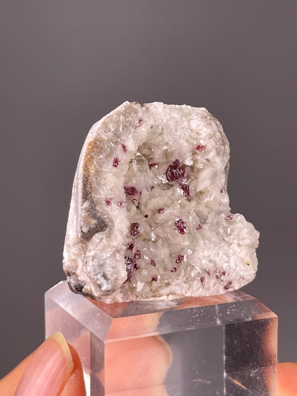 Cinnabar specimen from Hunan, China displaying reddish crystals in white matrix