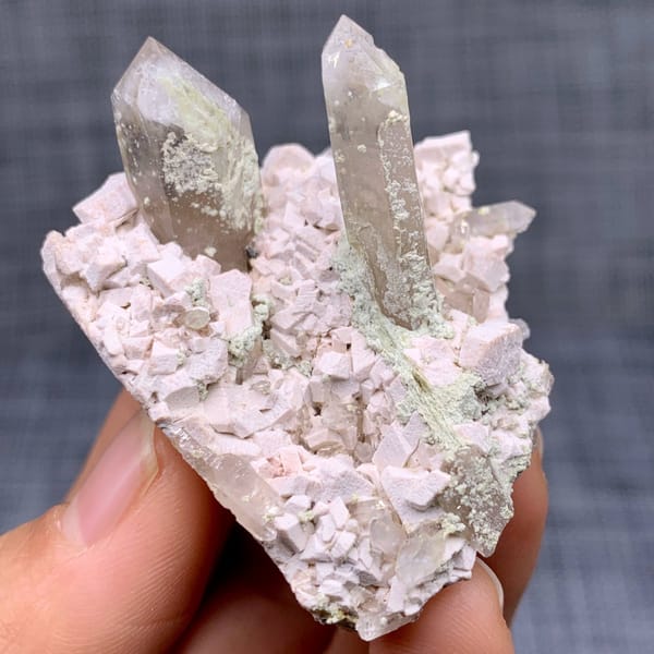 Two clear quartz points on pink feldspar from Fujian, China, view 2 of 11
