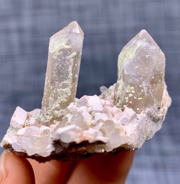 Two clear quartz points on pink feldspar from Fujian, China, view 4 of 11