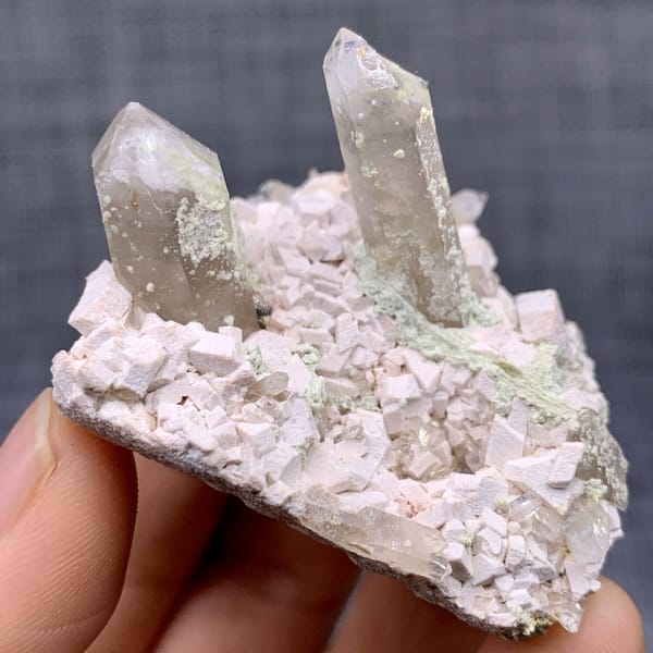 Two clear quartz points on pink feldspar from Fujian, China, view 6 of 11
