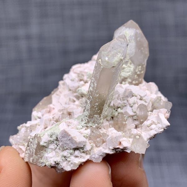 Two clear quartz points on pink feldspar from Fujian, China, view 8 of 11