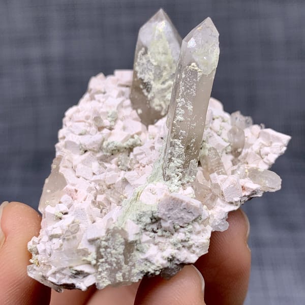 Two clear quartz points on pink feldspar from Fujian, China, view 10 of 11