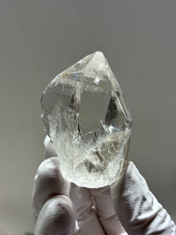 Clear quartz point with complete tip and mica from Xuebaoding, Sichuan, China, second angle
