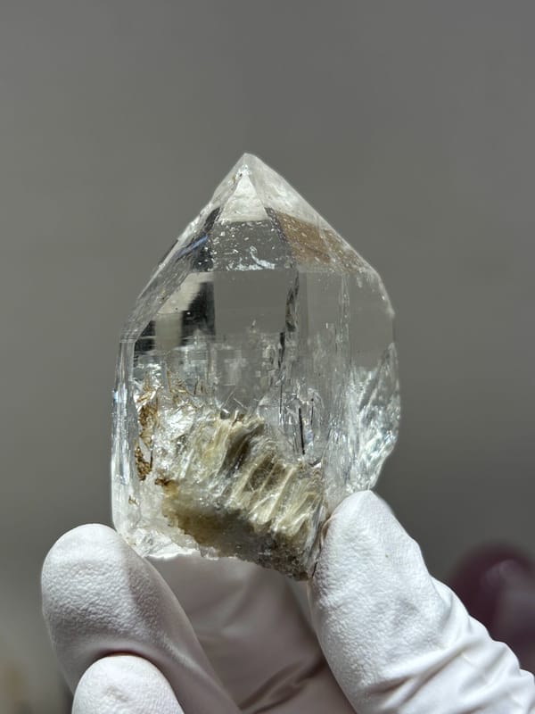 Clear quartz point with complete tip and mica from Xuebaoding, Sichuan, China, reverse side
