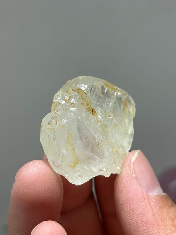 Colourless aquamarine crystal with golden staining from Xuebaoding, Sichuan, China
