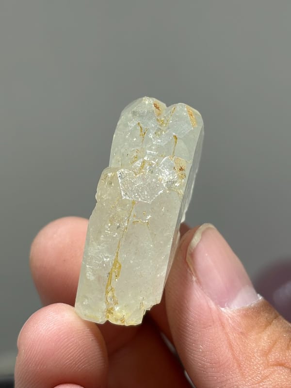 Colourless aquamarine crystal with golden staining from Xuebaoding, Sichuan, China, view 5 of 5