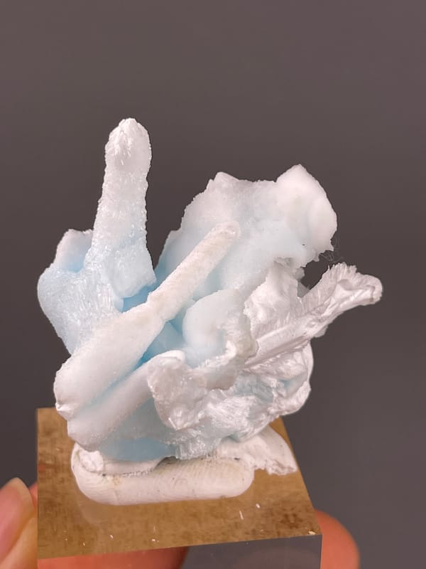 Blue Aragonite specimen from Yunnan, China presenting pale blue and white columns