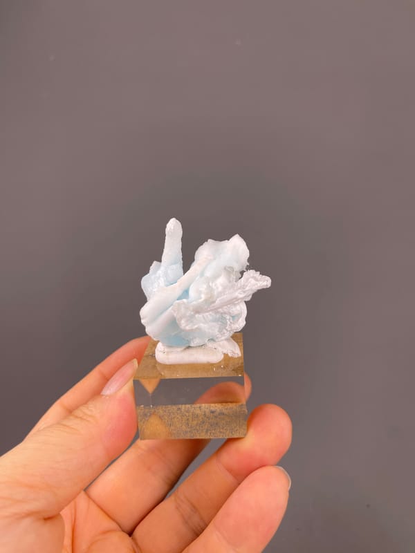 Blue Aragonite specimen from Yunnan, China displaying pale blue and white columns