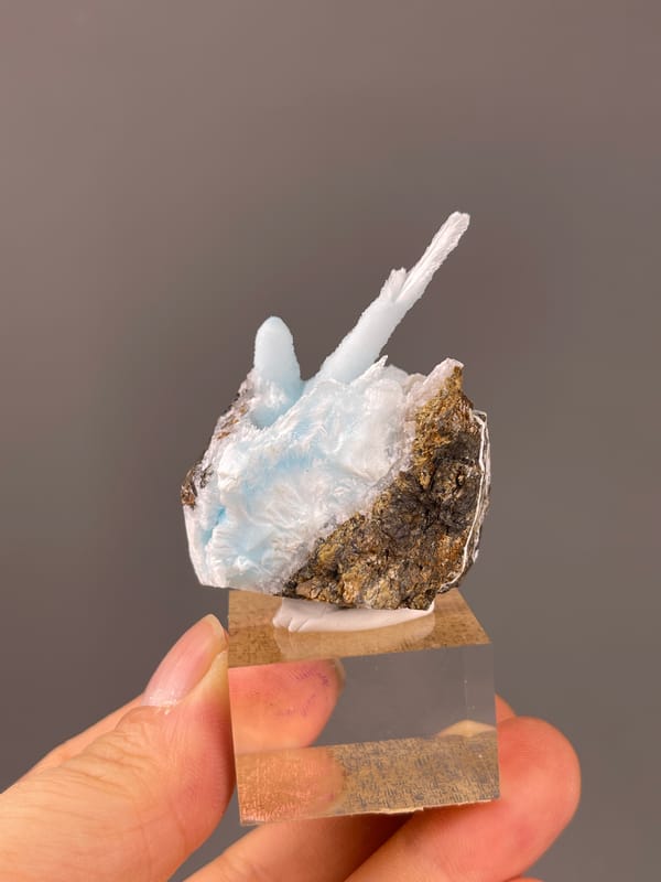 Blue Aragonite specimen from Yunnan, China featuring pale blue columns on matrix