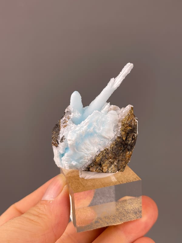 Blue Aragonite specimen from Yunnan, China showing pale blue columns on matrix
