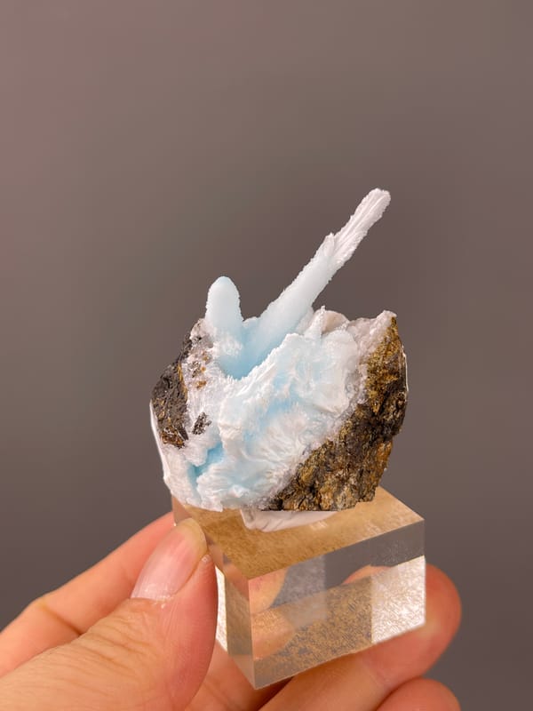 Blue Aragonite specimen from Yunnan, China, defined by pale blue columns on matrix